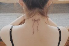 Elegant bow tattoo on the neck