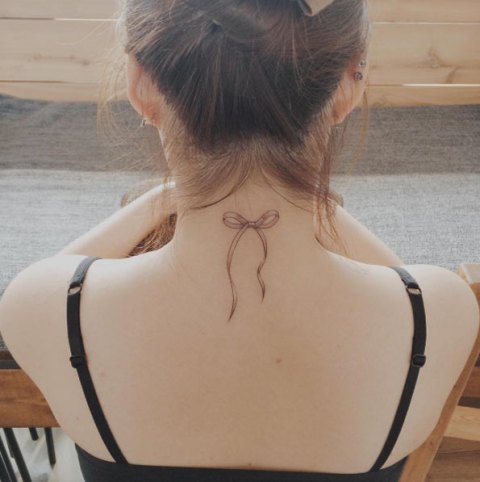 Elegant bow tattoo on the neck
