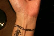 Feather bracelet tattoo