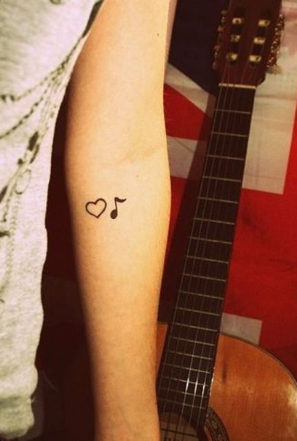 Heart tattoo with note one on the arm