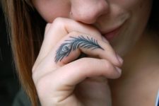 Peacock feather finger tattoo idea