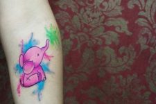 Purple, blue and green tattoo on the arm