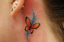 Red and orange butterfly behind the ear