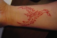 Red phoenix and flames tattoo