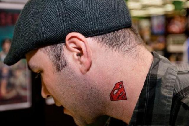 Red superman sign tattoo