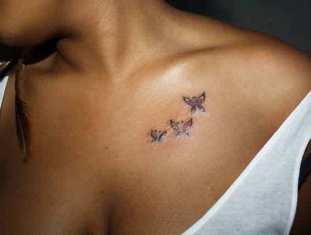 Three colored butterflies on the left collarbone