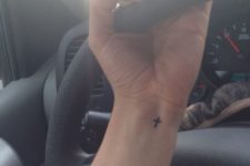 Tiny cross on the left wrist