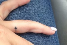 Tiny cross tattoo