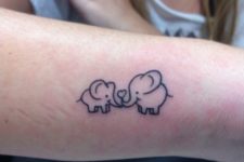 Two elephants tattoo on the arm