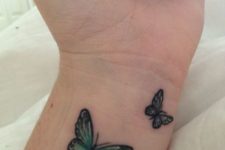 Two green butterflies on the left wrist