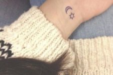 Two small tattoos on the left wrist