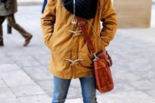 With duffle coat, cuffed jeans, brown boots, beanie and crossbody bag