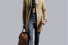 With elegant coat, tweed trousers, leather brown boots and big bag