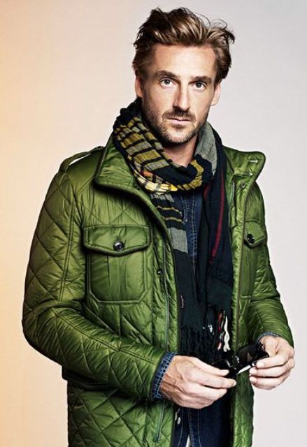 With green puffer jacket and denim shirt
