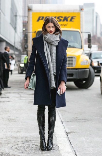 With navy blue coat, high boots and pants