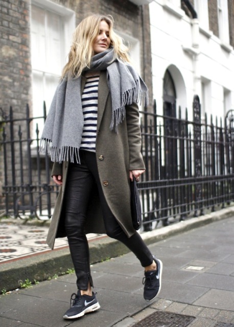 With printed shirt, leather pants, sneakers and olive green coat