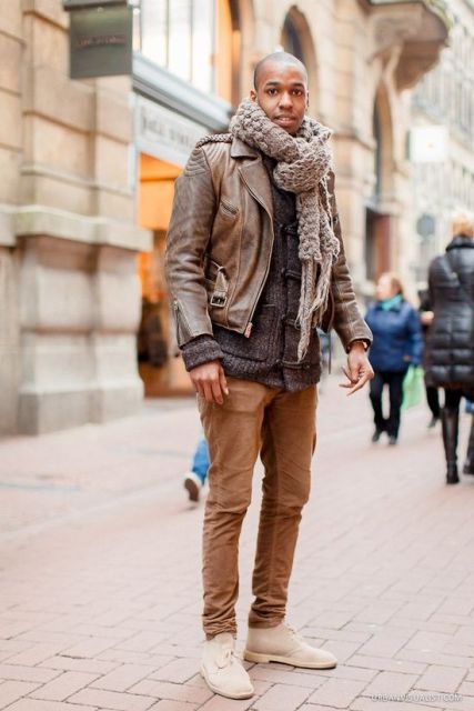 With sweater, leather jacket, brown pants and white boots