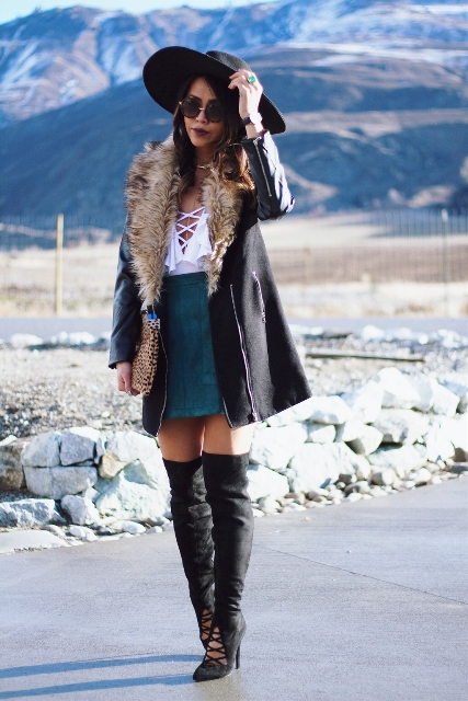 With white blouse, suede skirt, black hat and over the knee boots