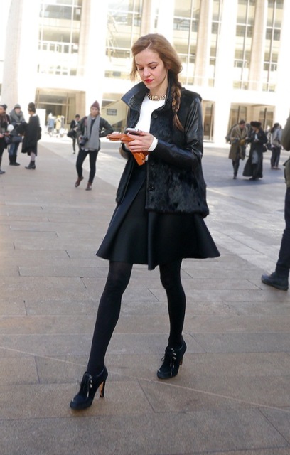 With white shirt, black skirt, black tights and ankle boots