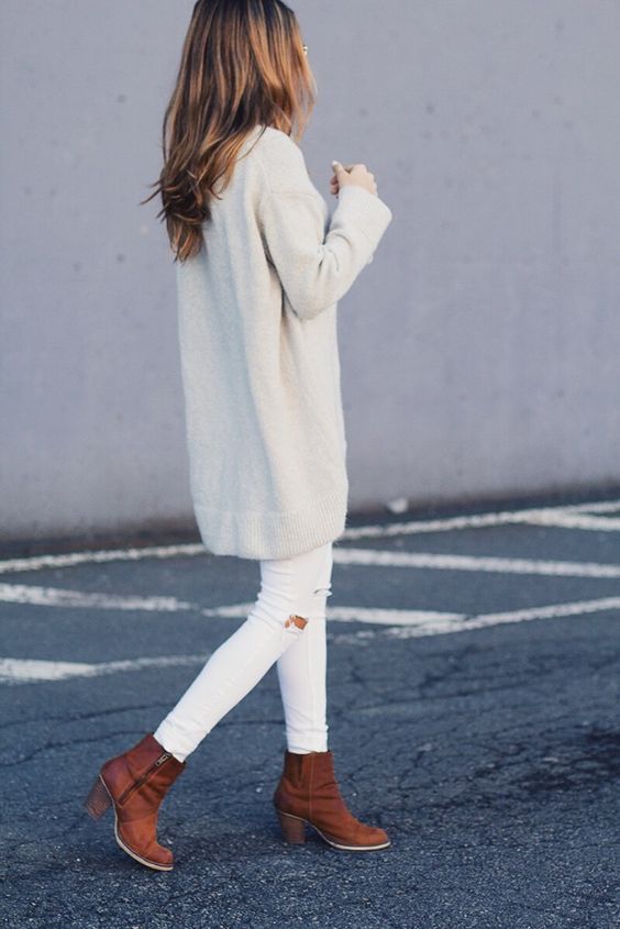 white ripped jeans, an oversized white sweater and brown ankle boots