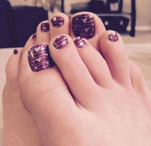 dark purple pedicture and pink hearts on it