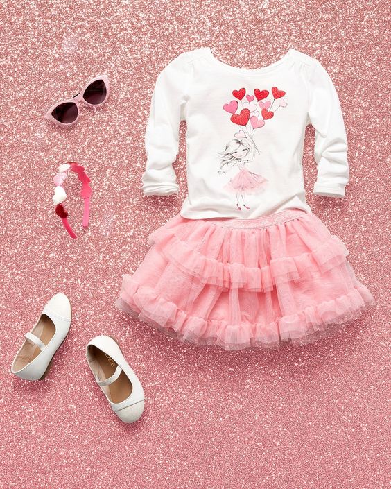 pink ruffled tulle skirt, a printed heart swetshirt and white shoes