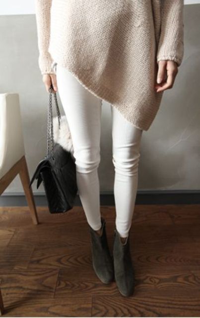 white jeans, a blush oversized sweater and dark grey ankle boots