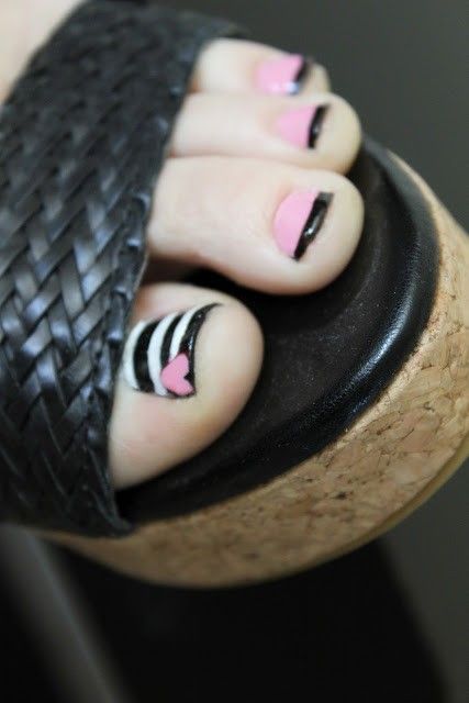 pink and black nail art with stripes