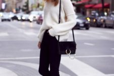15 black heels, a white chunky knit sweater and black denim