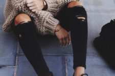 17 black ripped jeans, black sneakers, a striped t-shirt and a chunky knit brown cardigan