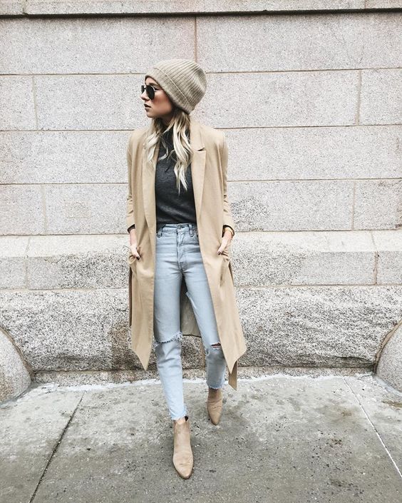 distressed jeans, a black tee, a camel coat and flat boots