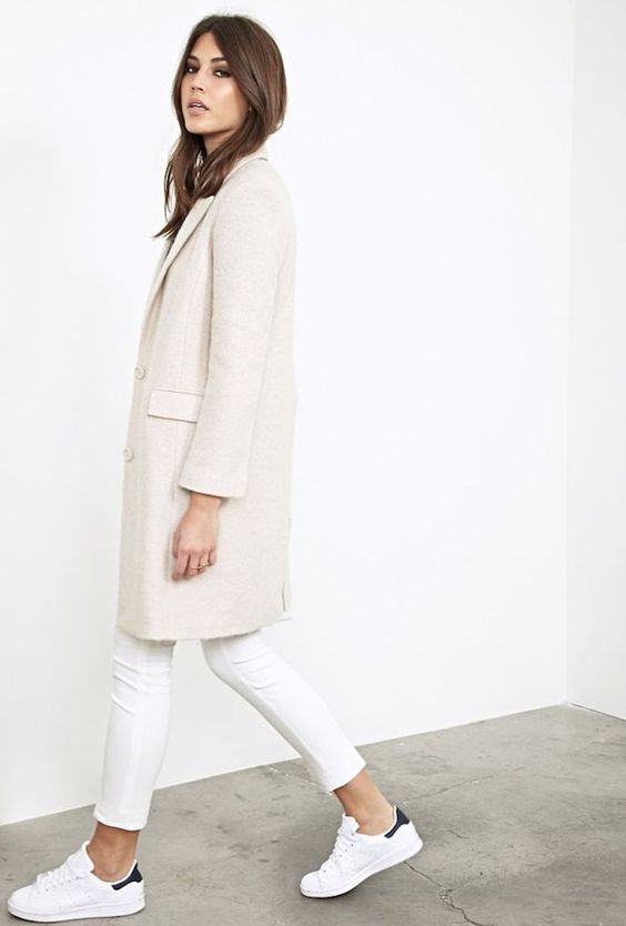 an ivory coat, white jeans and chucks for a comfy look