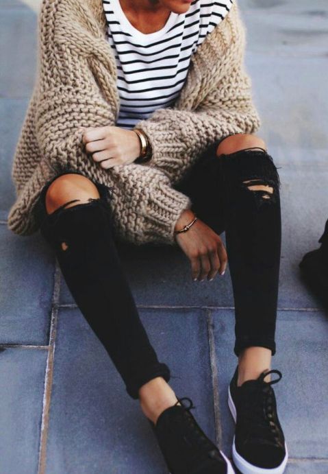 striped tee, an oversized beige cardigan, ripped black jeans and chucks