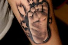 Baby footprint tattoo on the arm