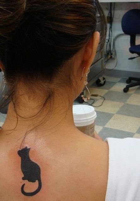 Black cat tattoo on the back