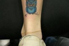 Blue owl tattoo on the leg