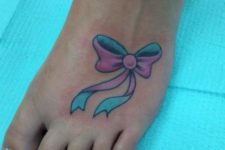 Colorful bow tattoo on the foot