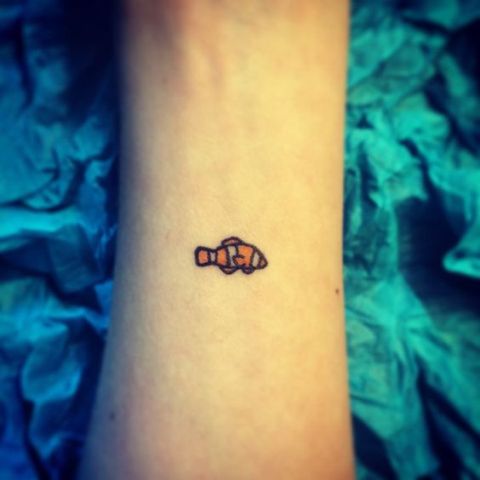 Cute tiny tattoo on the arm