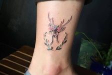Deer with flowers tattoo on the ankle