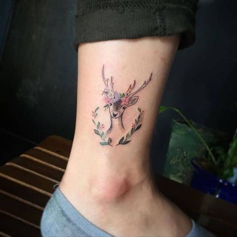 Deer with flowers tattoo on the ankle