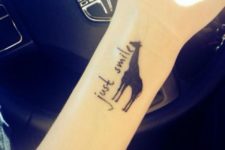 Giraffe with just smile words tattoo