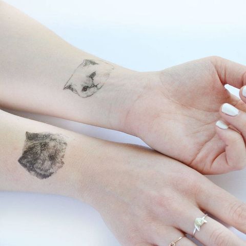 Portrait cat tattoos on the wrists