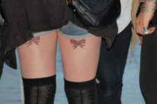 Red bow tattoos on the legs