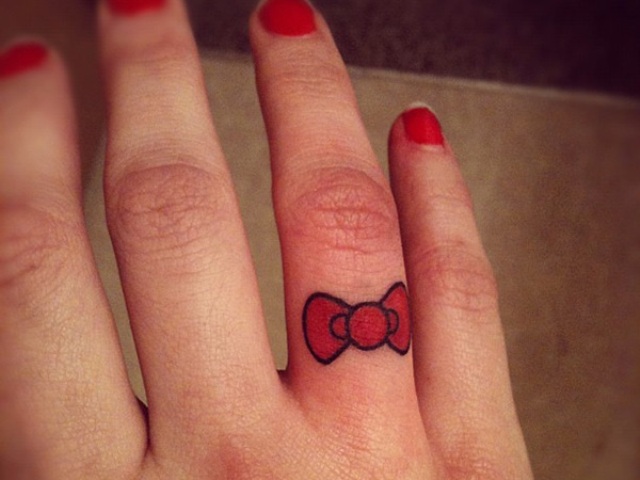 Red tattoo on the finger