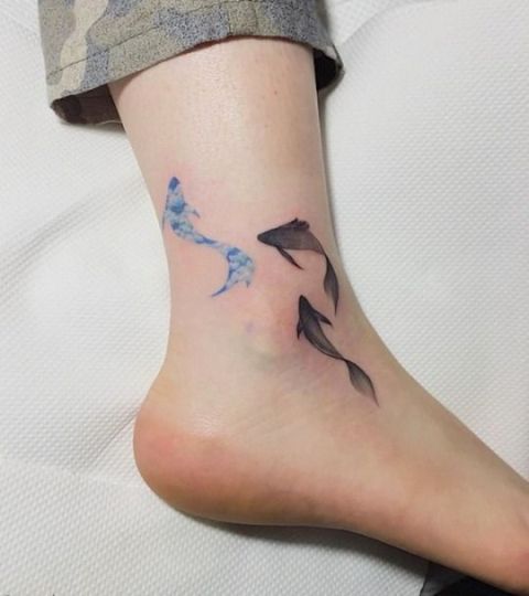 Several fishes tattoo on the ankle