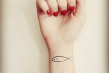 Simple fish tattoo on the wrist