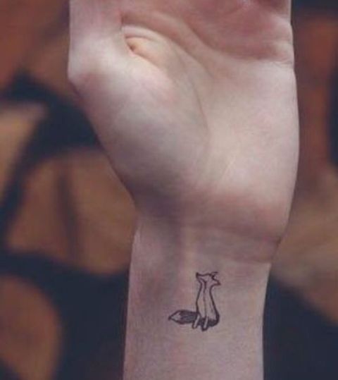 Simple tiny fox tattoo on the wrist