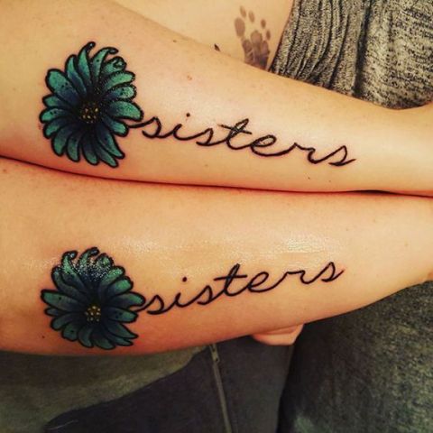 Sister word tattoos with green flowers