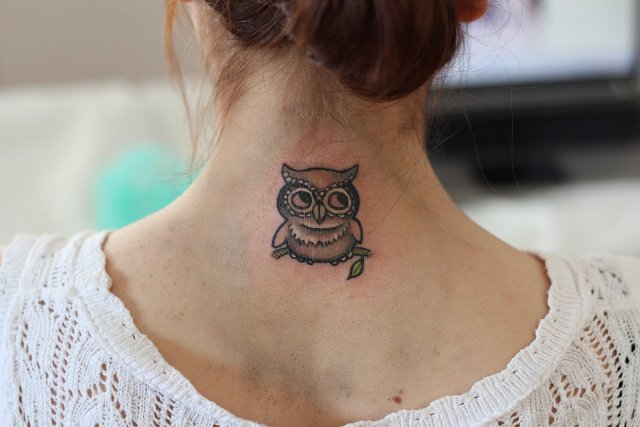 Small owl tattoo on the back