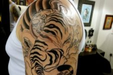 Tiger half sleeve tattoo on the left arm